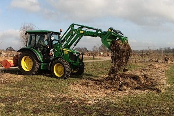 Air raiding a compost bed with a tractor with grabble